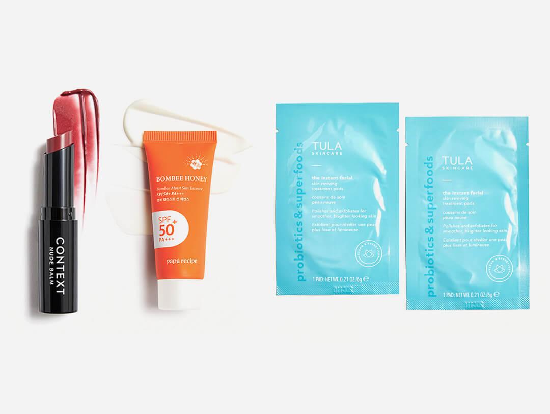 CONTEXT SKIN Nude Balm in Back for More, PAPA RECIPE Bombee Moist Sun Essence, and TULA SKINCARE The Instant Facial Dual-Phase Skin Reviving Treatment Pads swatched on white background Desktop