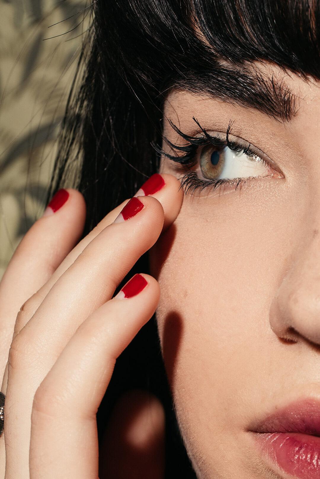 A closeup photo of a model's face with long doll lashes Desktop