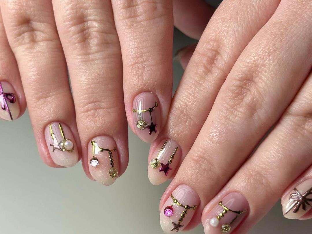 An image of hands with Christmas-inspired decorations as nail art Desktop