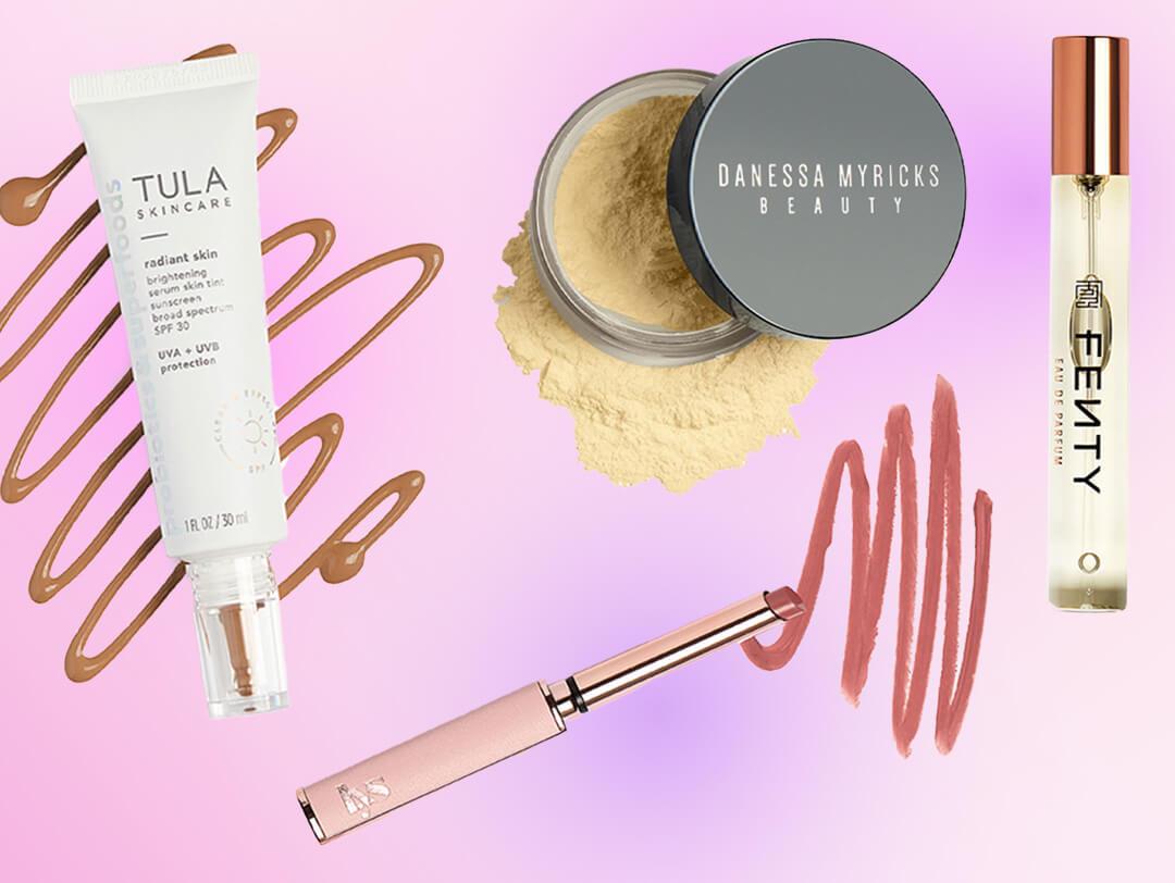 Skincare and makeup products from various brands on colorful background Desktop