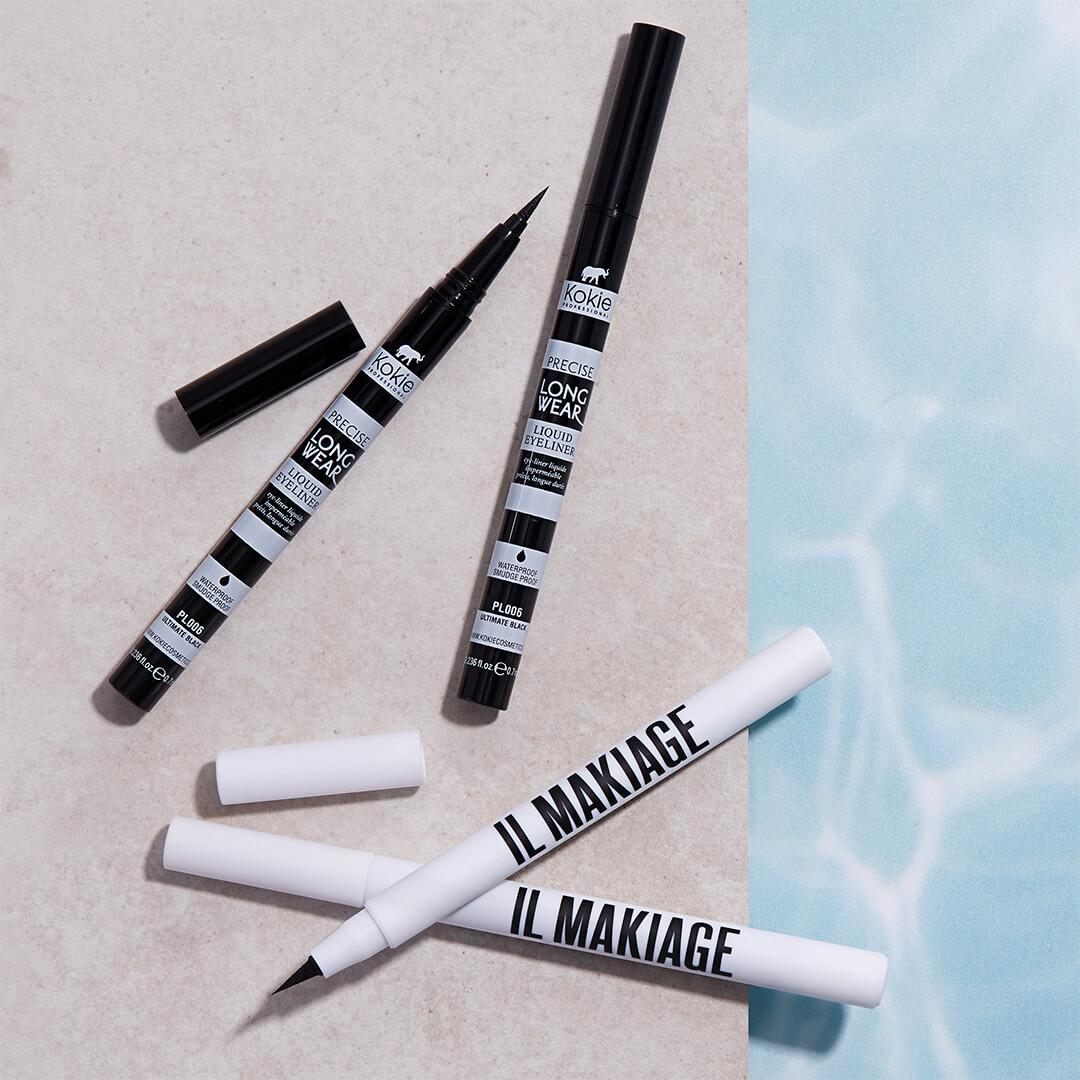 Flat-lay image of IL MAKIAGE Black Card Waterproof Liquid Eyeliners and KOKIE COSMETICS Precise Longwear Liquid Eyeliners on the edge of a pool Desktop
