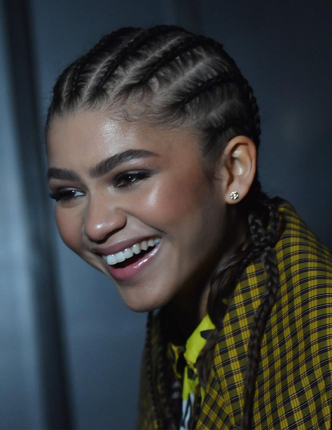 Zendaya in a yellow plaid jacket and classic cornrows hairstyle Desktop