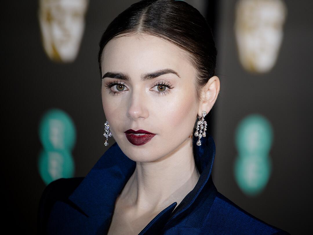 Close-up of Lily Collins with minimal face makeup paired with burgundy lips Desktop