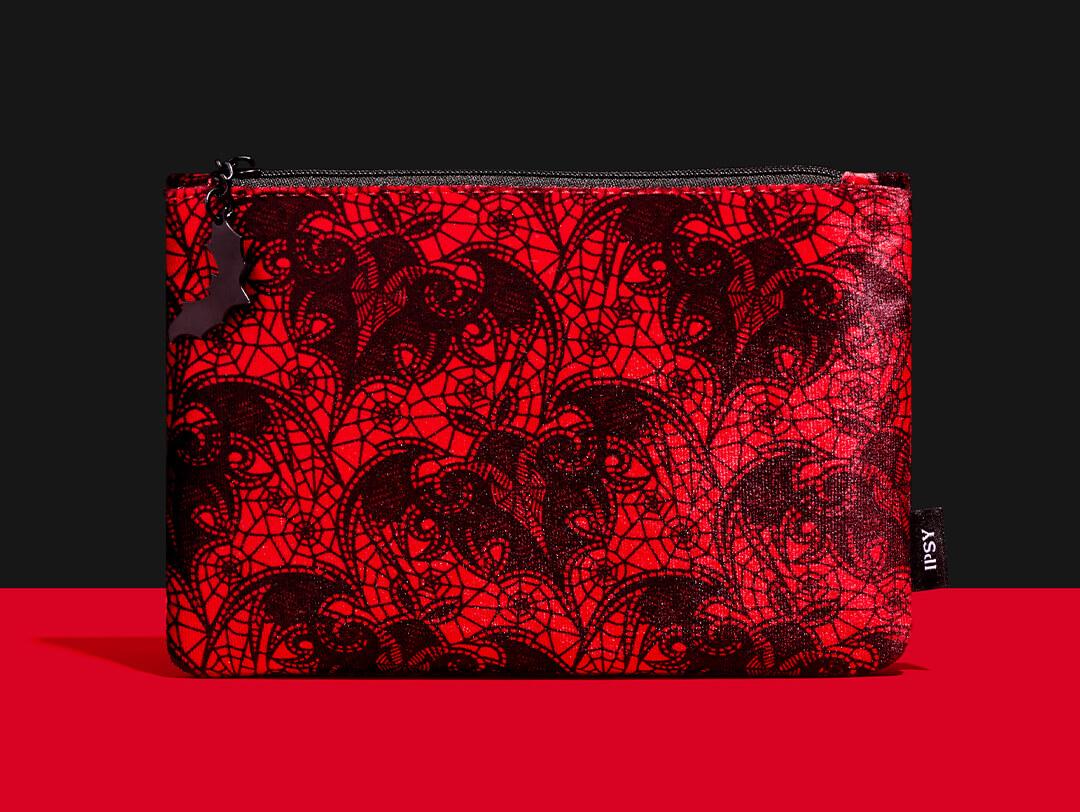 October 2023 IPSY Glam Bag on black ground and red surface Desktop