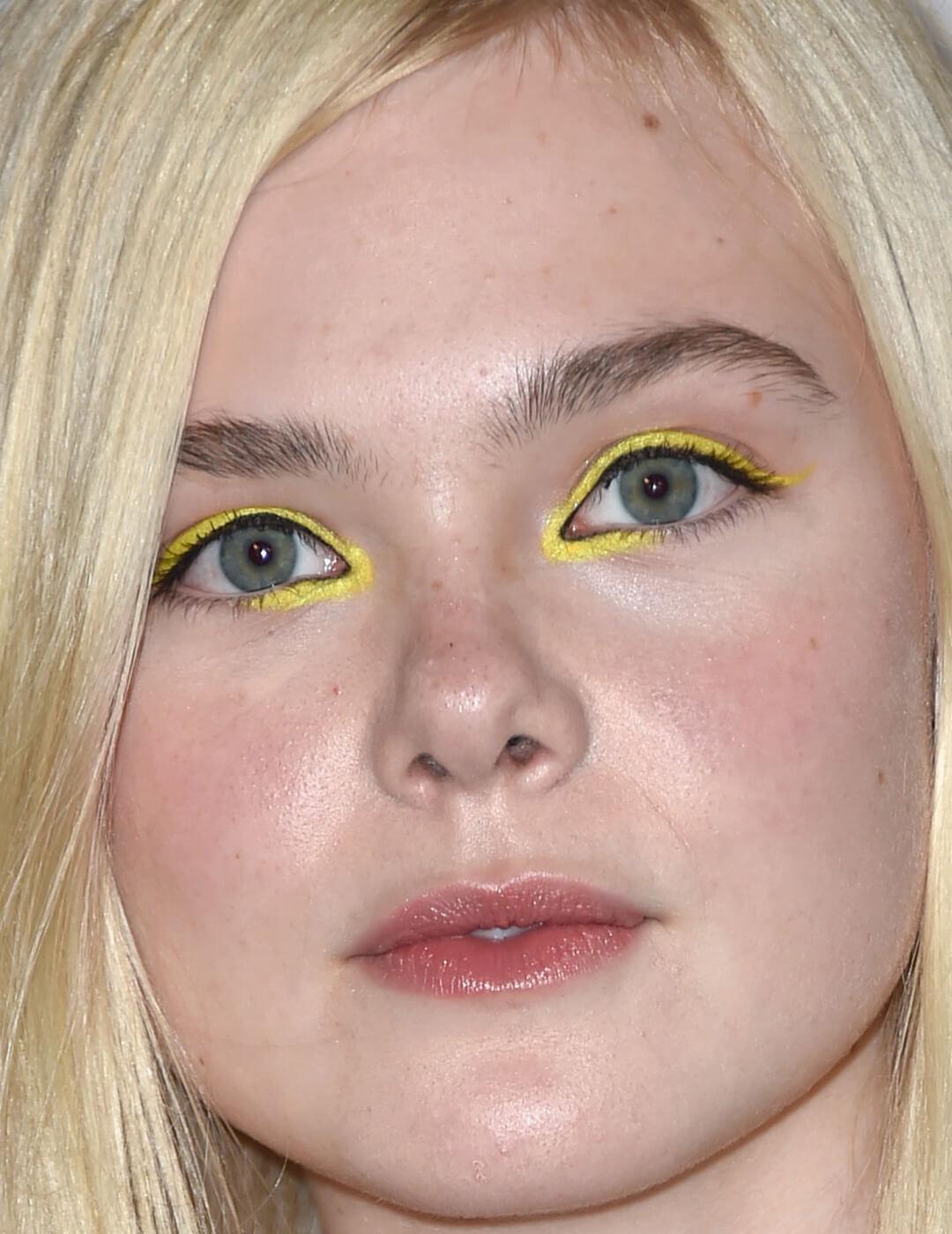 Close-up image of Elle Fanning rocking a yellow eyeliner look Desktop