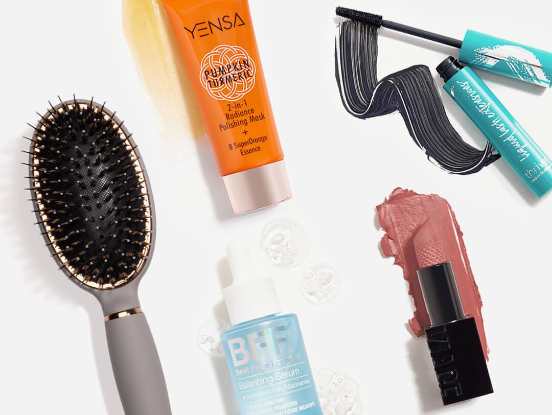 Makeup, skincare, and hair care products and tools from the November 2021 IPSY Glam Bag Plus swatched on white background Desktop