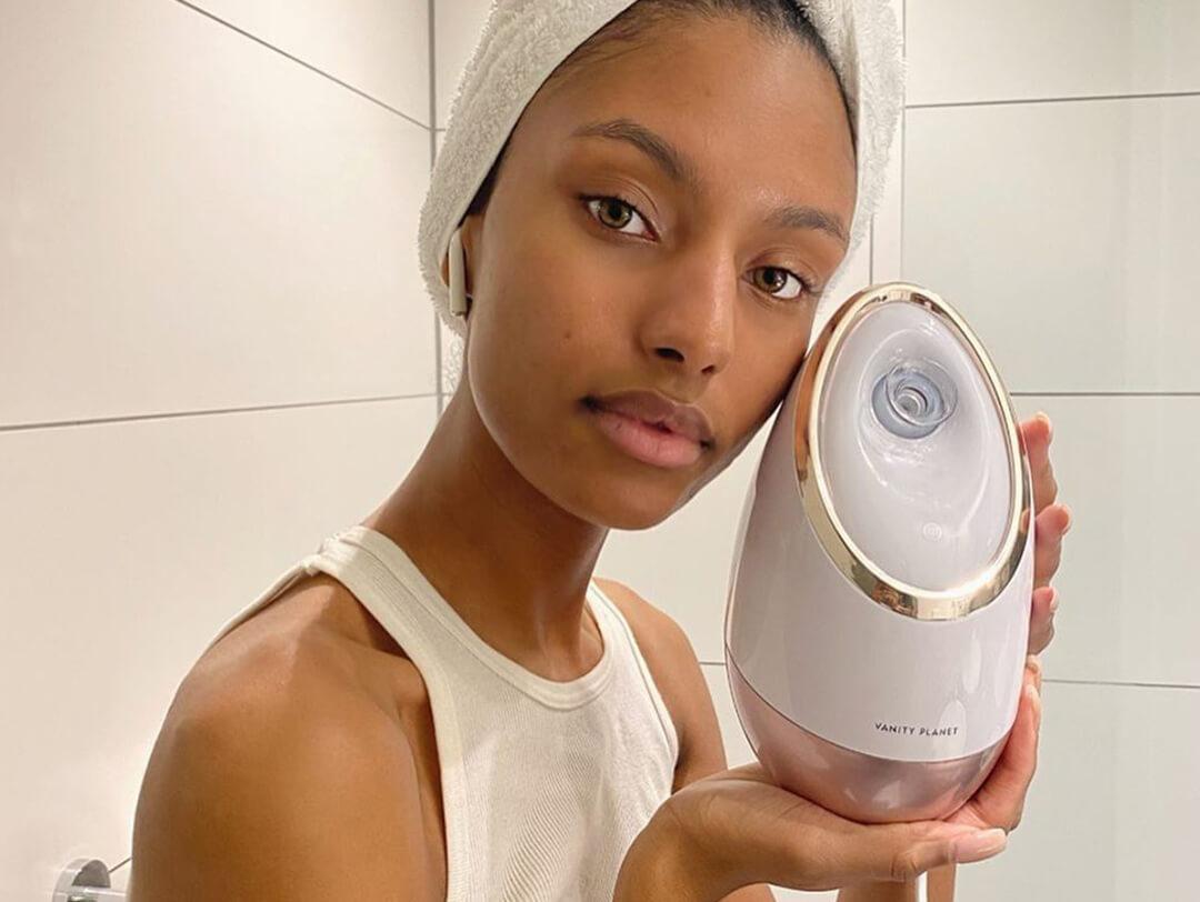 A photo of a model holding a facial streamer in a bathroom Desktop