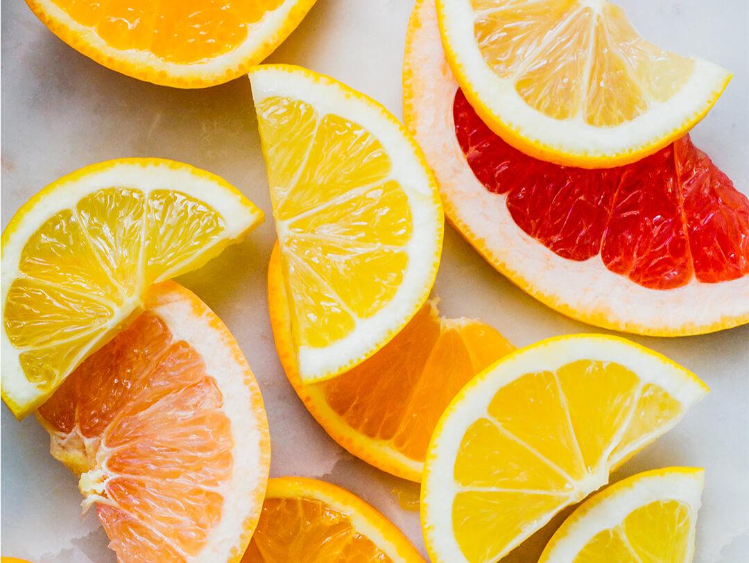 Image of orange, lemon, and grapefruit slices on a gray surface Desktop