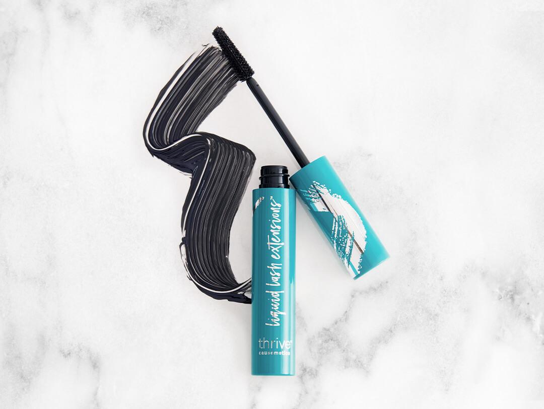 THRIVE CAUSEMETICS Liquid Lash Extensions Mascara™ in Brynn swatched on black and white marble background Desktop
