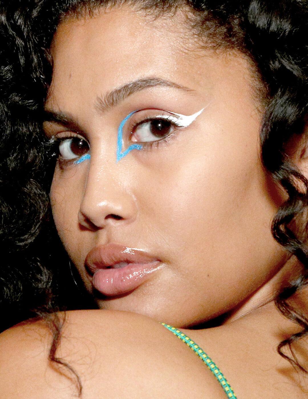 Leyna Bloom rocking a graphic blue and white eyeliner makeup look Mobile