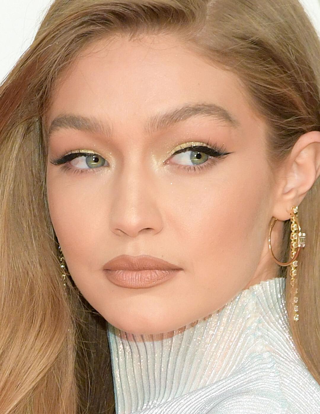 Close-up of Gigi Hadid rocking a neutral makeup look accented with gold eye shadow Mobile