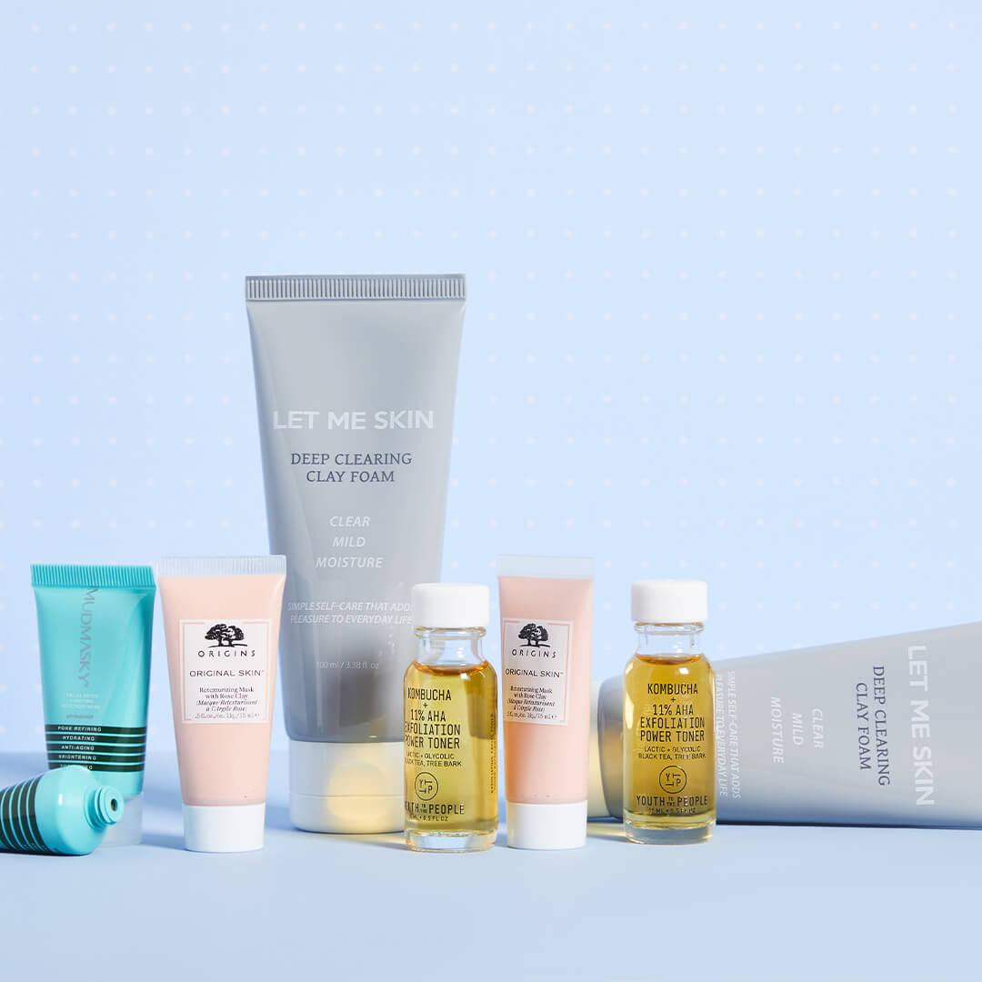 Image of skincare products of different formulas from various brands on light blue background Mobile