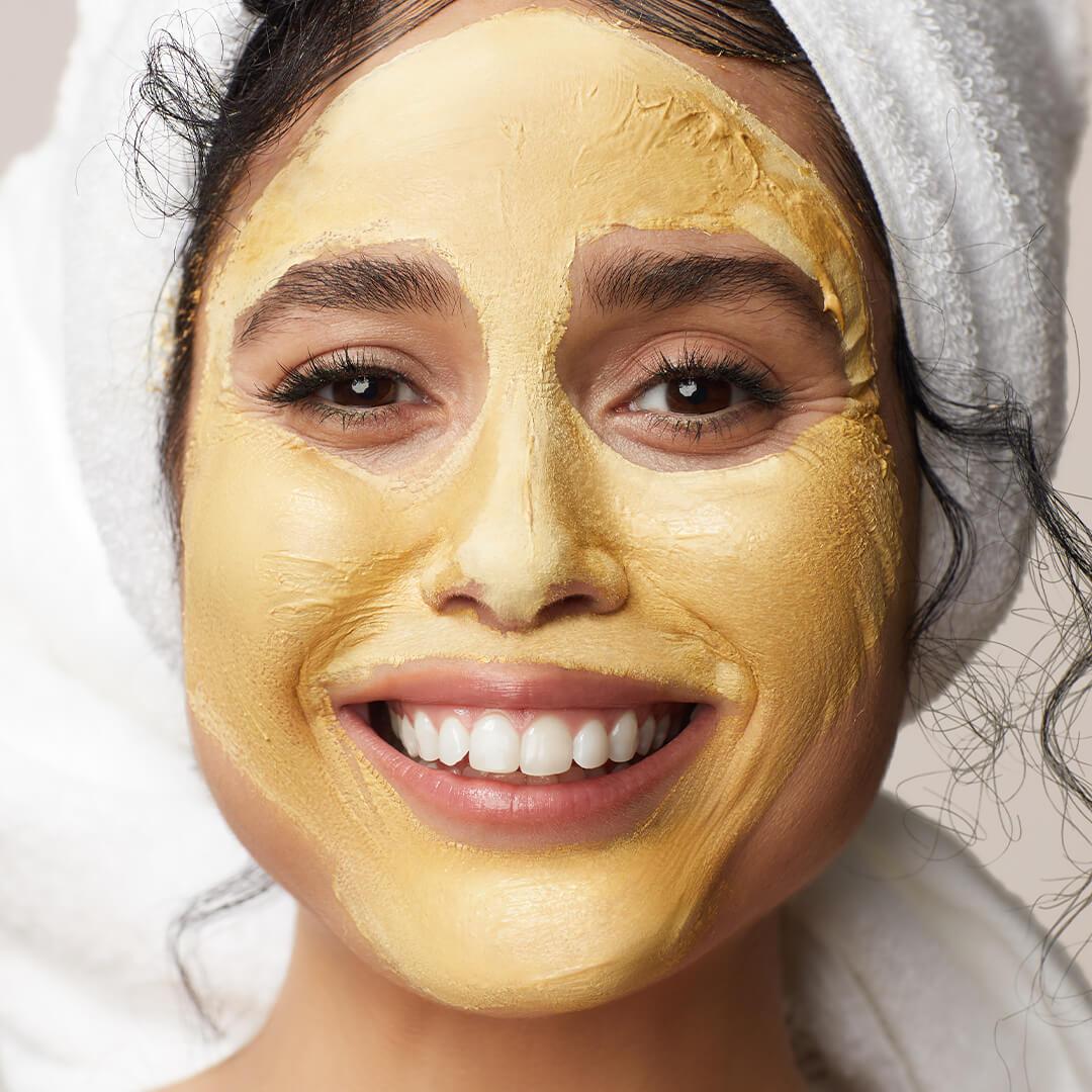 Close-up of a model with gold mask on her face Desktop