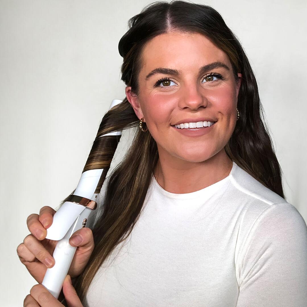 Image of Melissa Hurkman styling her hair with a curling iron Desktop