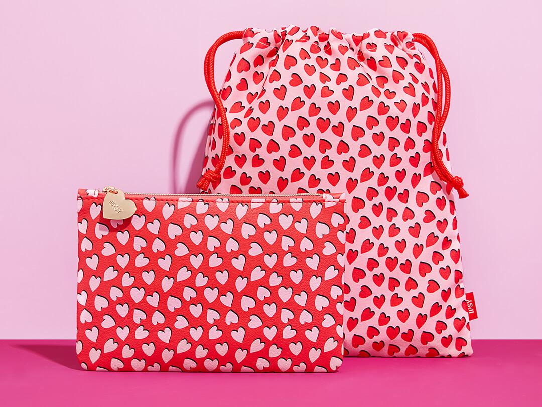 February 2022 IPSY Glam Bag and Glam Bag Plus bags on pink background Desktop