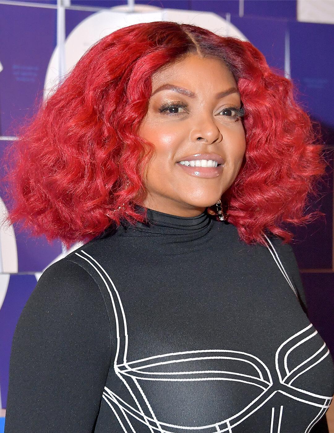 Taraji P. Henson looking bold in a graphic black and white outfit and red, middle-part curly hairstyle Mobile