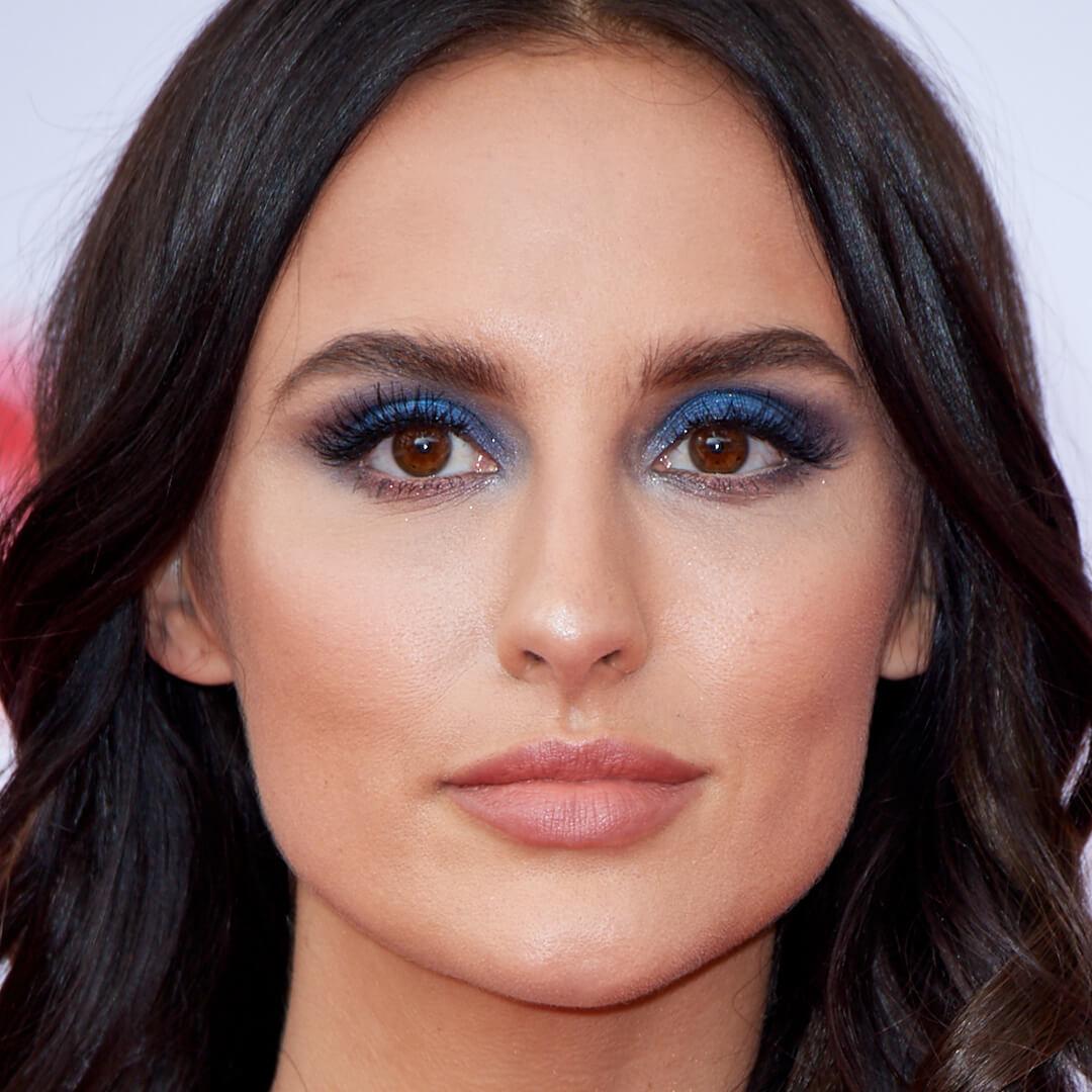 Close-up image of Lucy Watson rocking a sultry blue smoky eyeshadow look Mobile