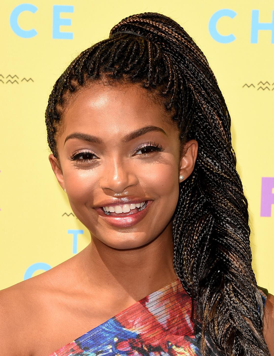 Smiling Yara Shahidi rocking fishtail braids hairstyle Mobile