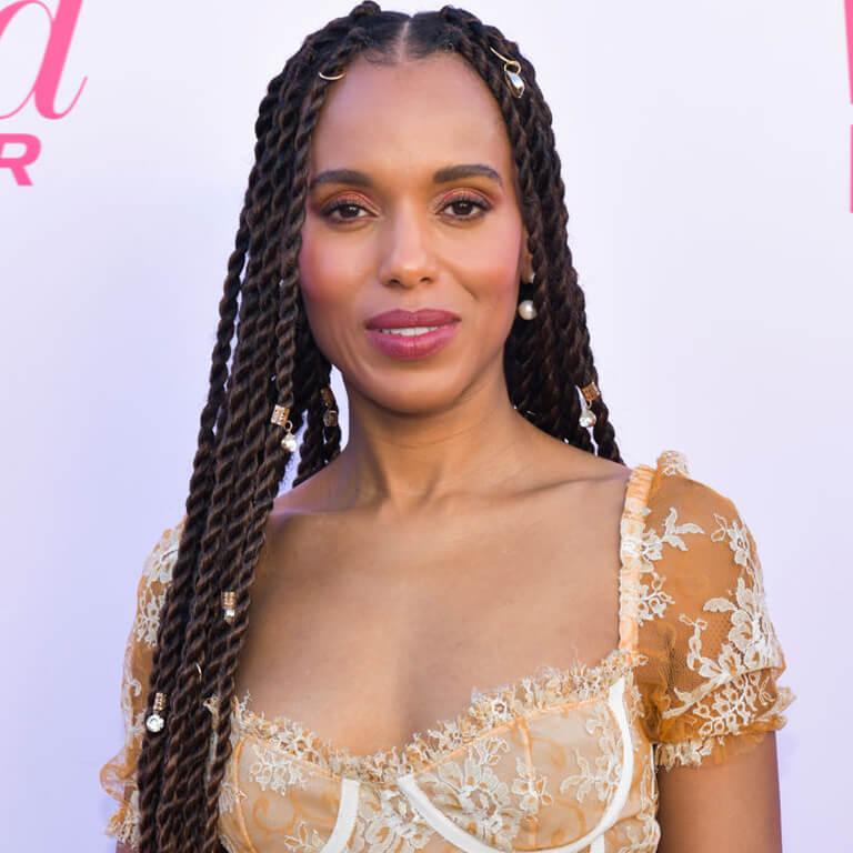 An image of Kerry Washington in a dark gold dress showing her long twisted hairstyle adorned with accessories Desktop