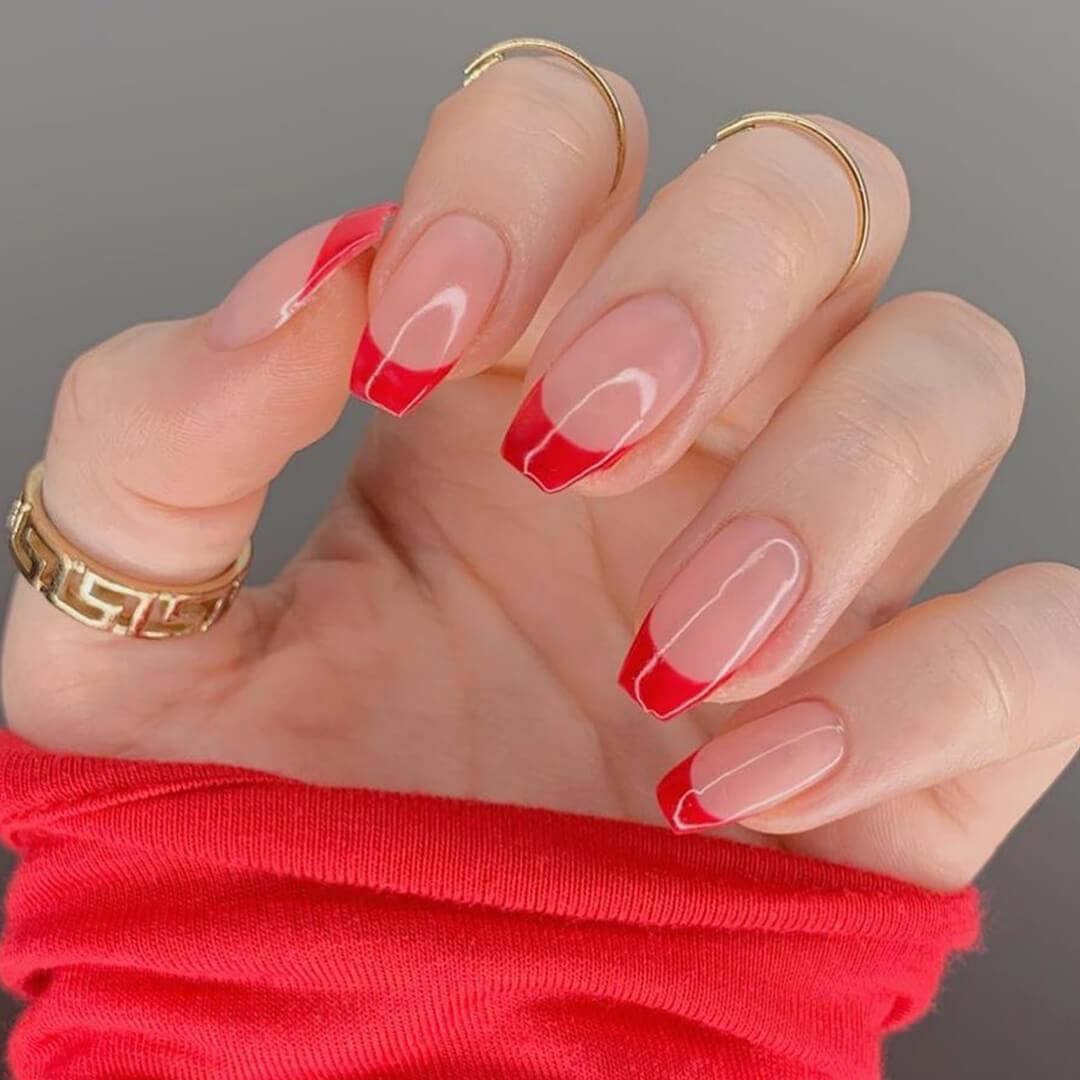Close-up of a woman's bright orange French tips nail mani Desktop
