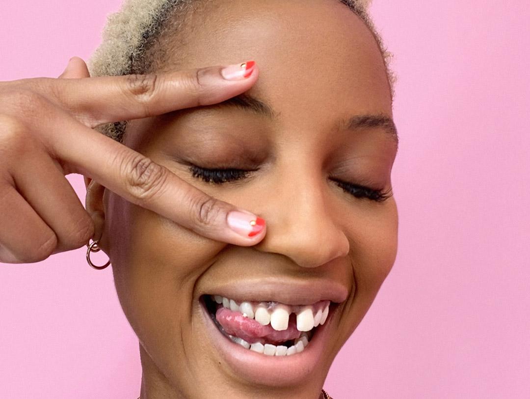 A photo of a model posing on pink background Desktop