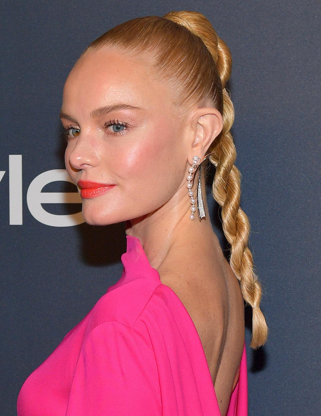 Kate Bosworth rocking a hot pink dress, minimal makeup look, silver dangling earrings, and twisted braids high ponytail hairstyle Desktop
