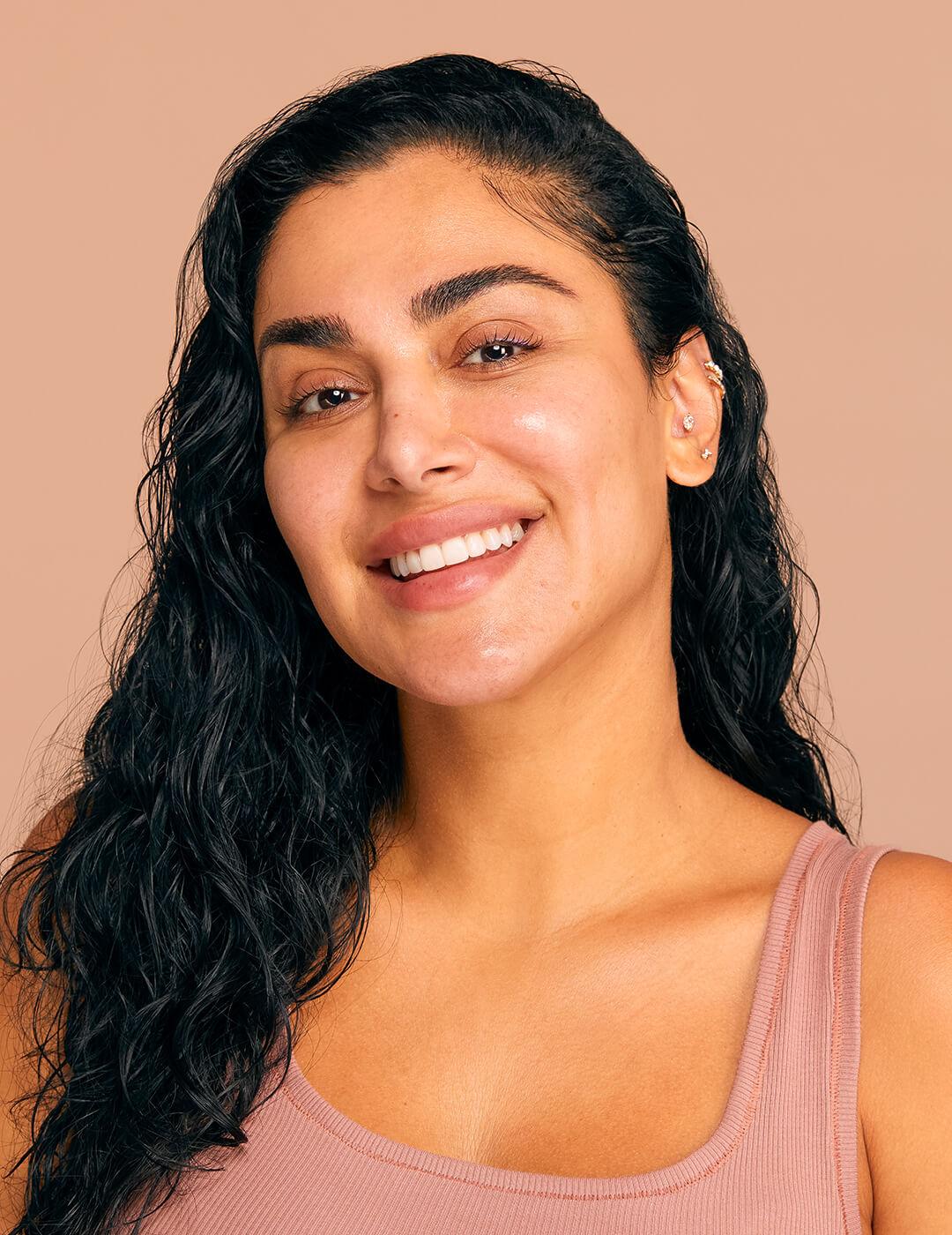 Close-up of Huda Kattan with damp hair and glowy bare face Desktop