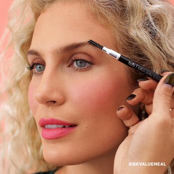 An image of a model taming her eyebrows using a spoolie Mobile