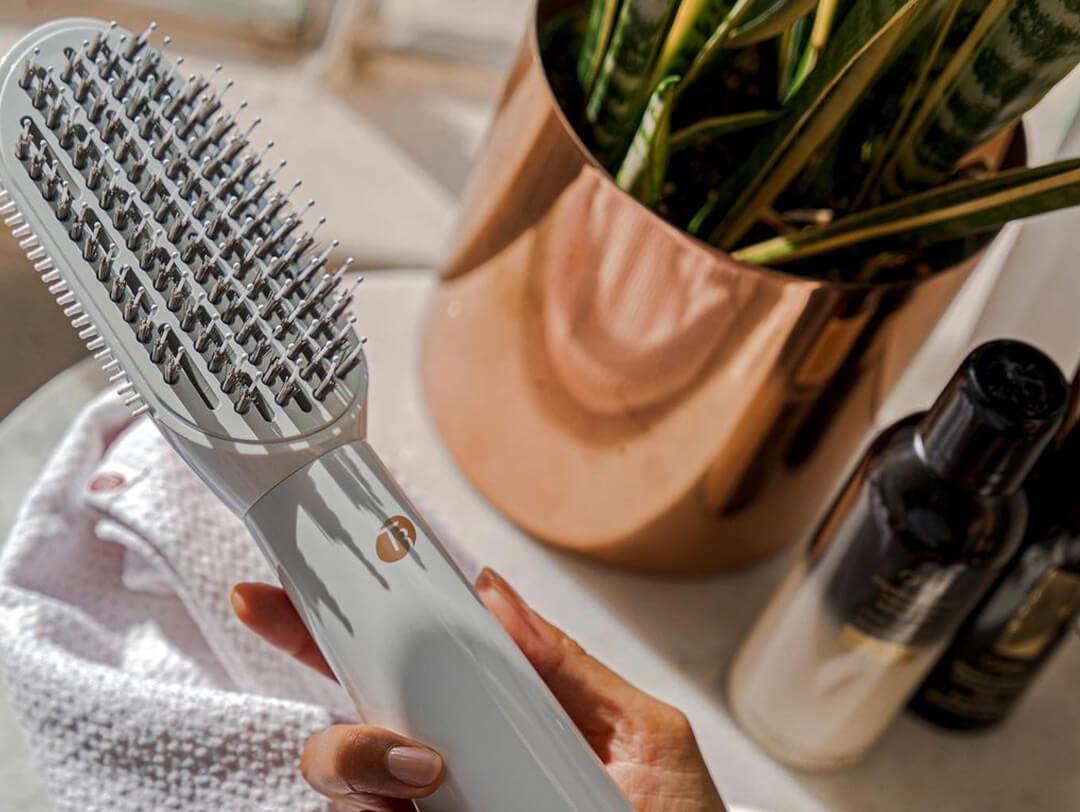 Woman holding a T3 AireBrush Duo in her bathroom Desktop