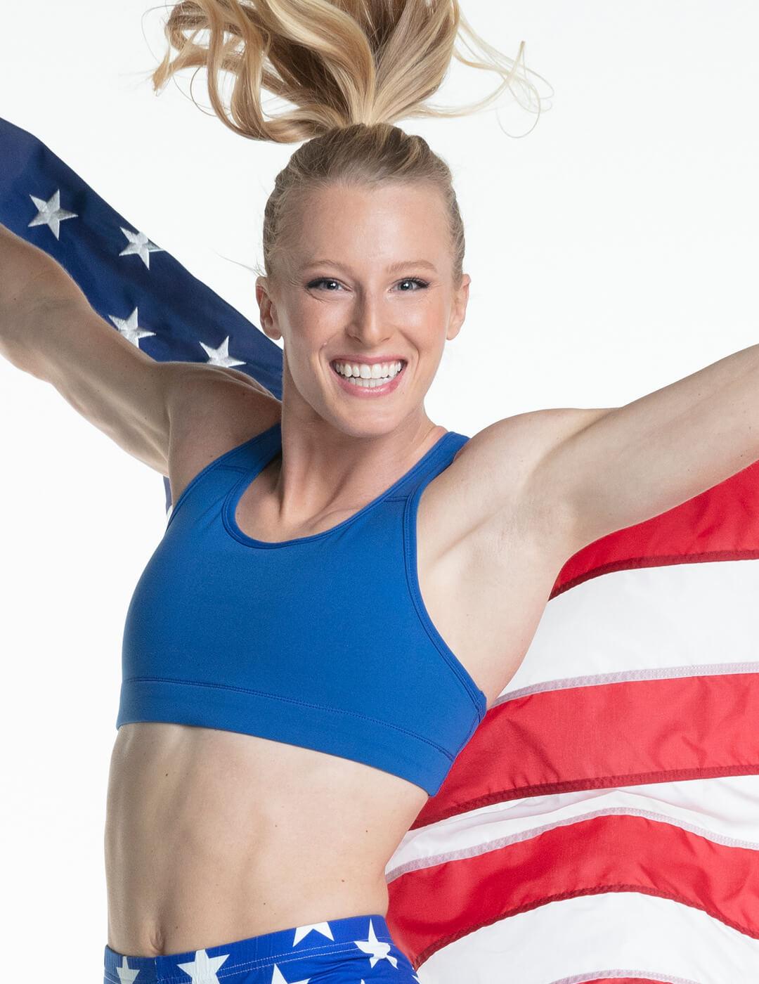 Sandi Morris smiling and holding the US flag behind her back Mobile