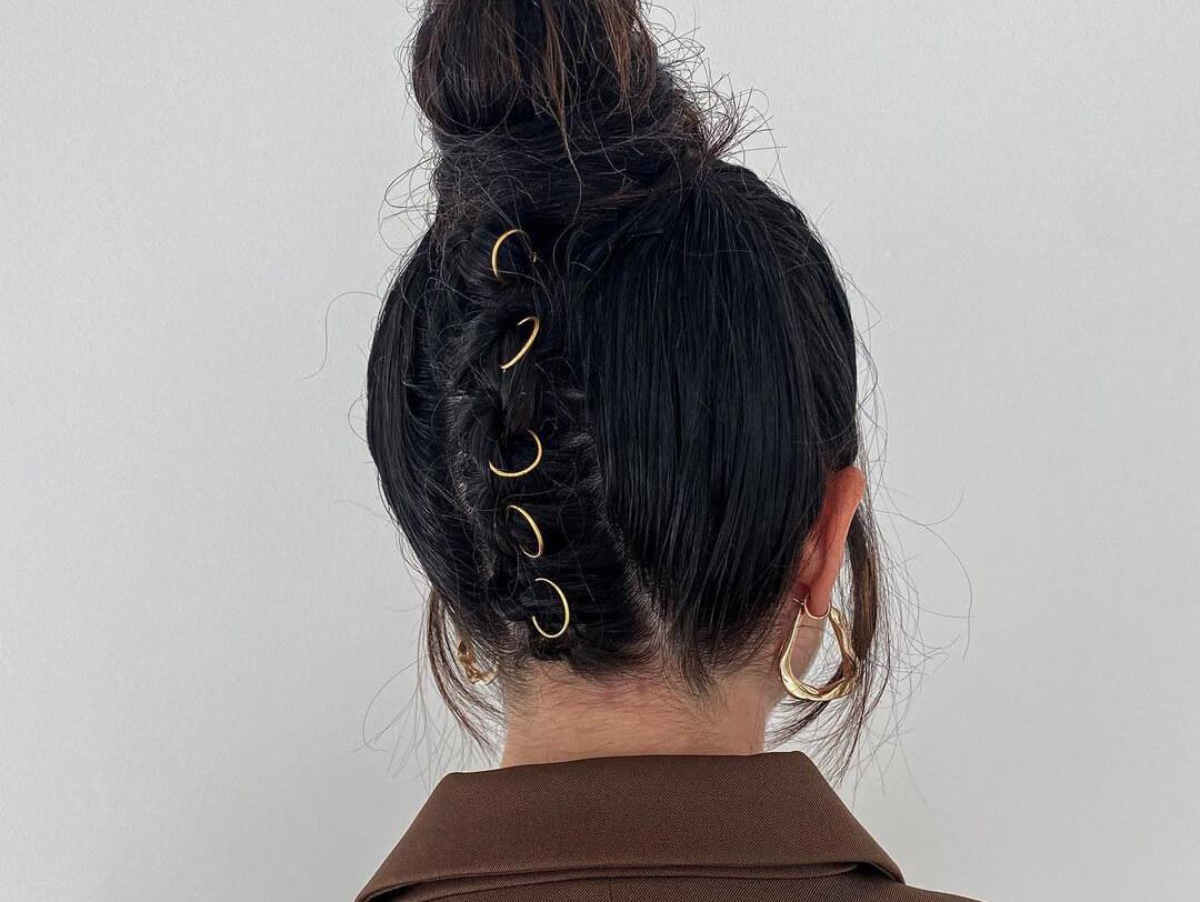 Back view of a woman's messy top bun hairstyle with hair rings Desktop