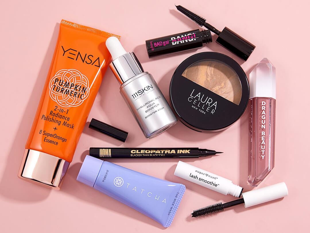 Makeup and skincare products from September 2021 IPSY Glam Bag on pink background Desktop