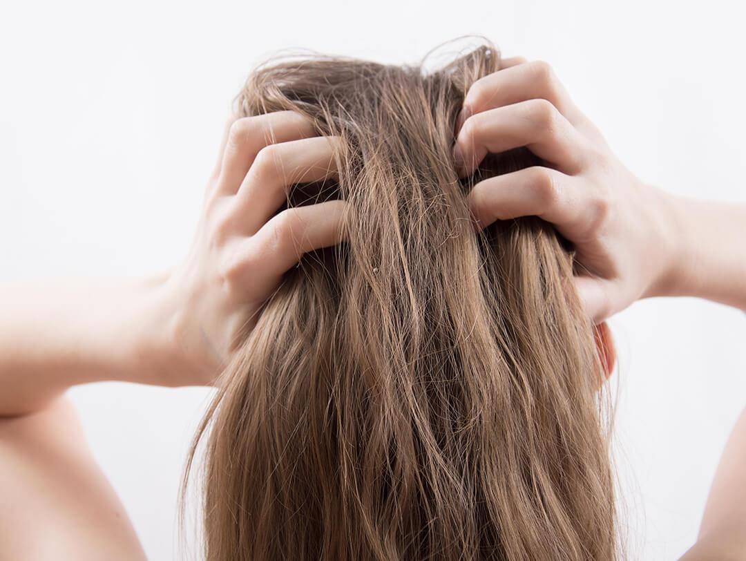 Image of a woman scratching her hair Desktop