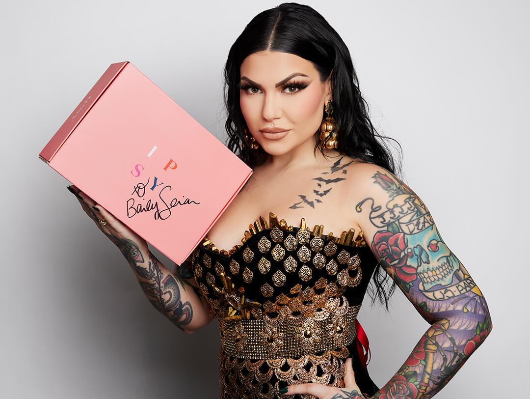 Bailey Sarian holding a signed pink IPSY box Desktop