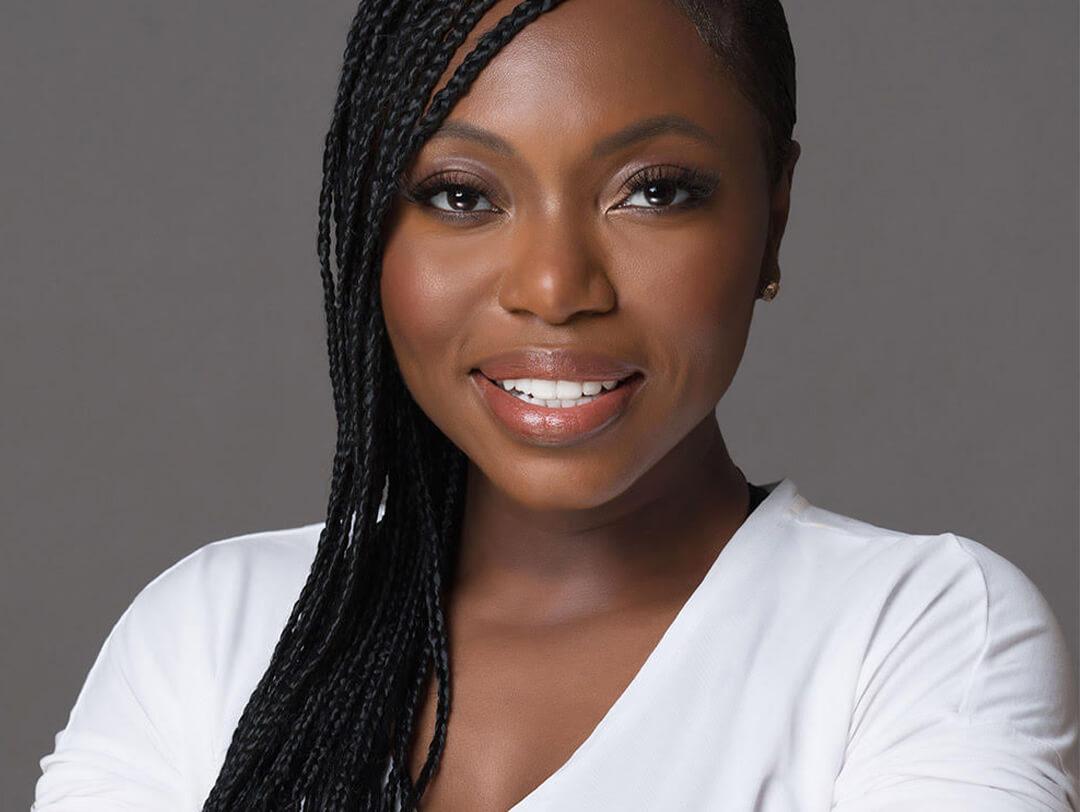 Close-up image of UOMA Beauty Founder Sharon Chuter in a white shirt Desktop