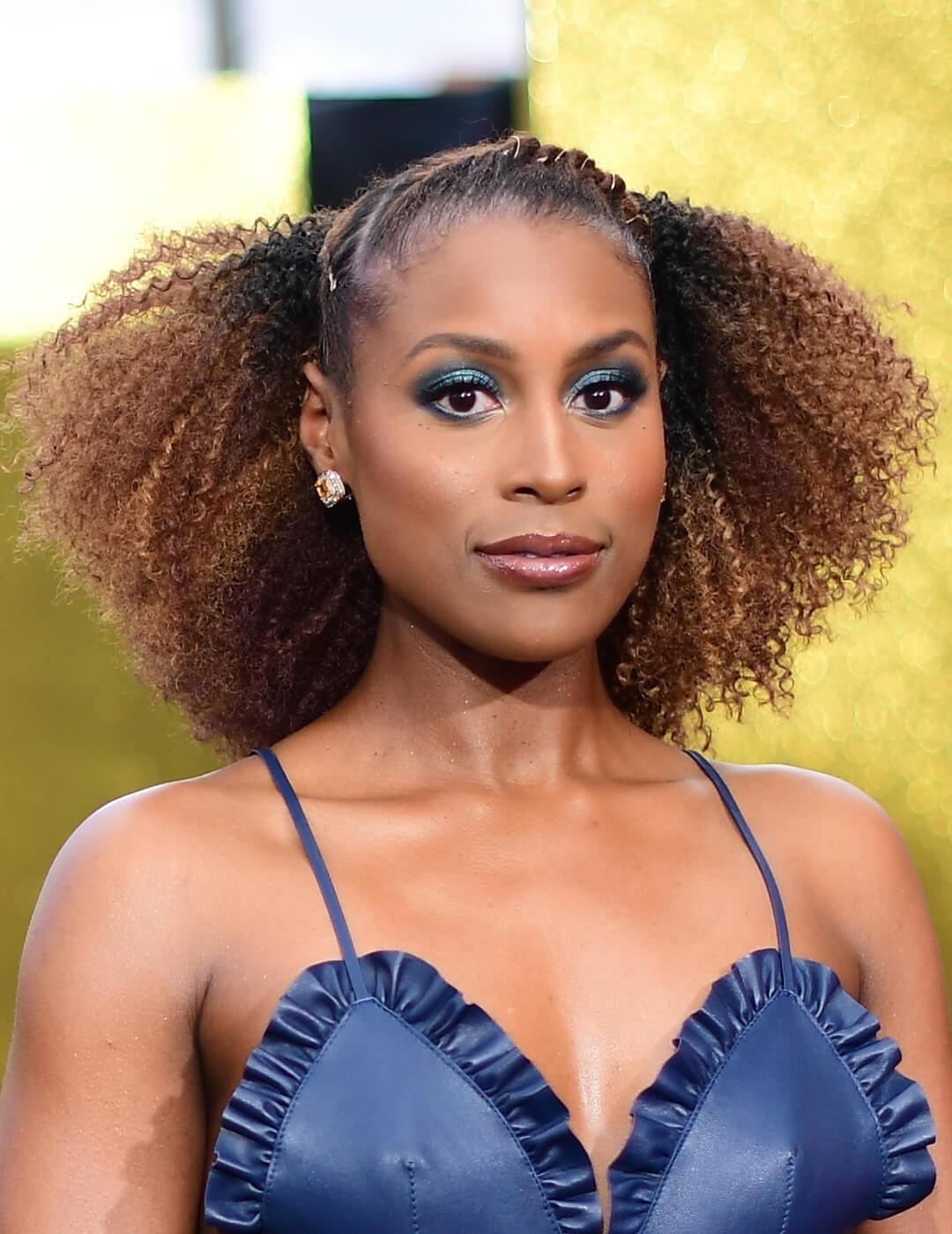 Issa Rae rocking a crochet braid hairstyle and blue leather dress Desktop