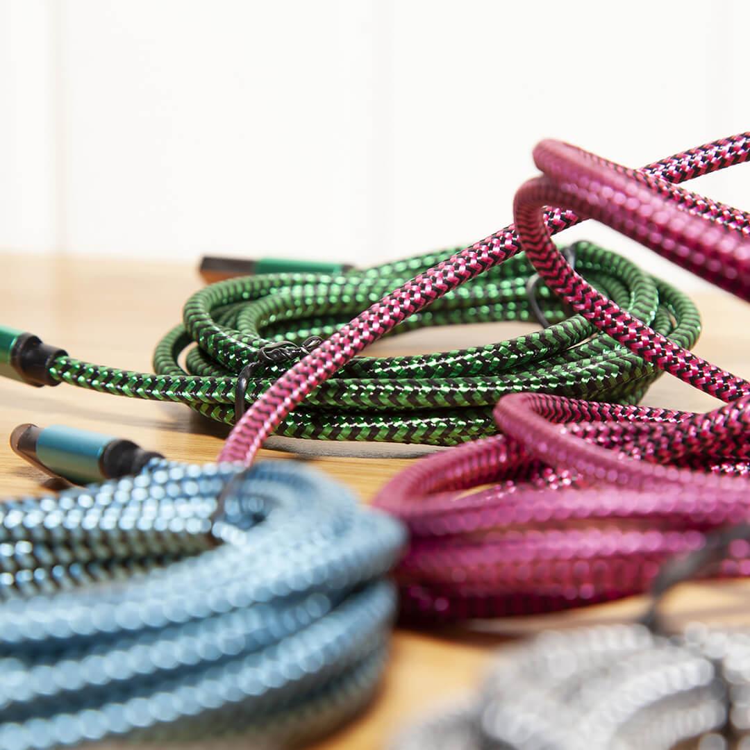 Green, blue, and pink charging cables on table top Mobile