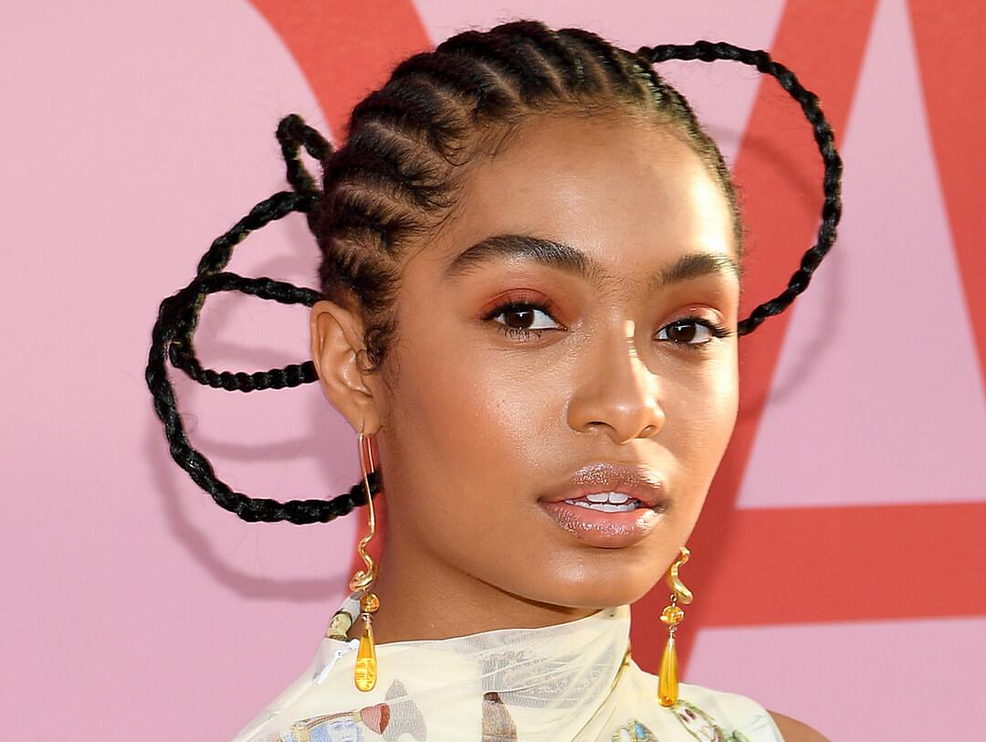 Yara Shahidi rocking a sculpted, braided hairstyle and burnt orange eyeshadow makeup Desktop