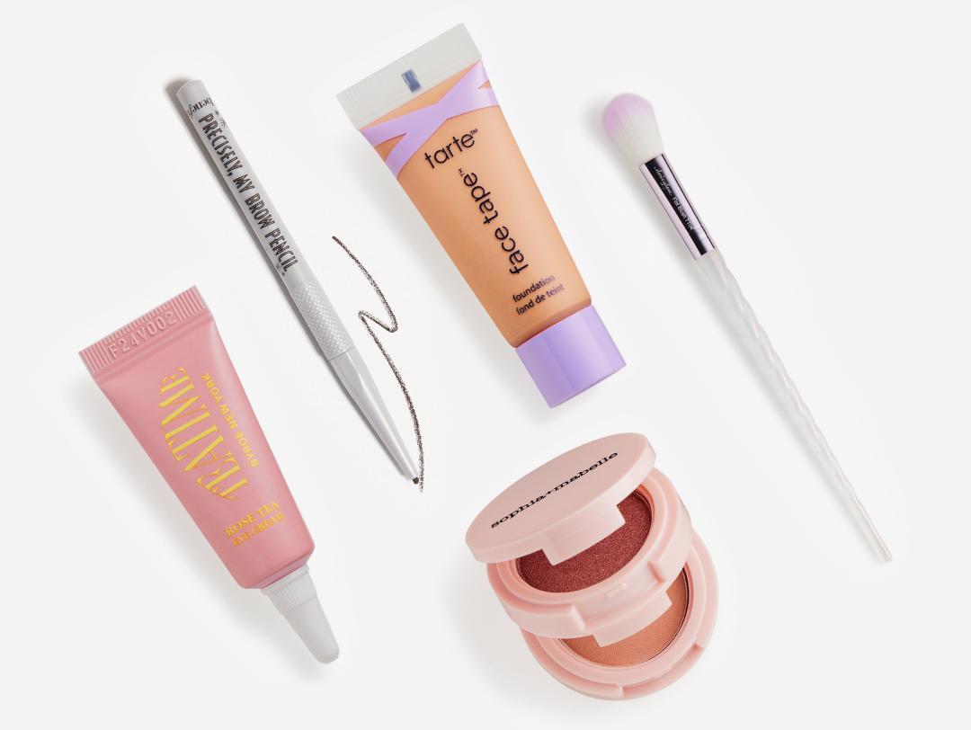 Makeup, skincare, and beauty products from the December 2022 IPSY Glam Bag on white background Desktop