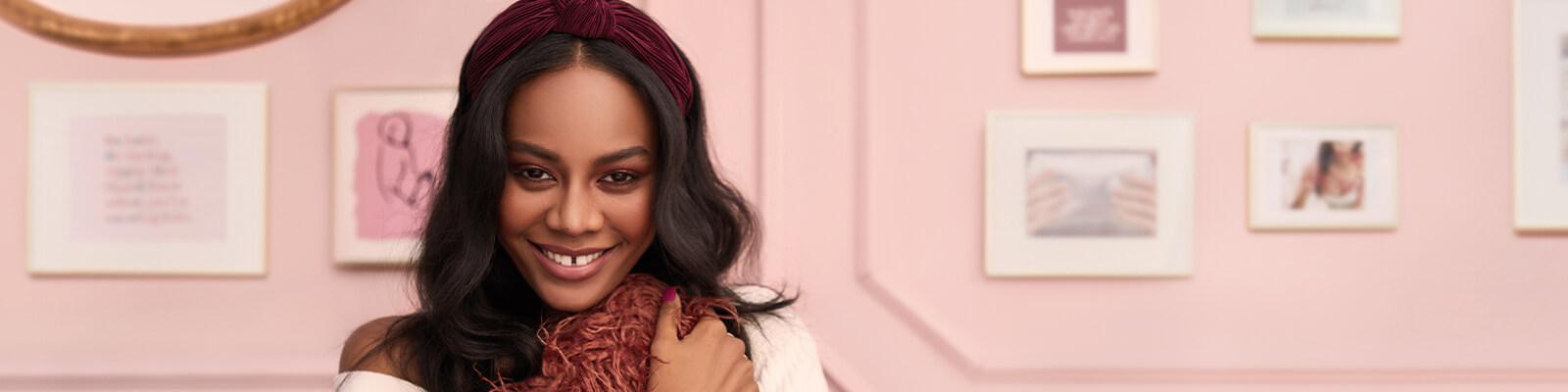 An image of a model with black, loose wavy hair wearing a dark maroon headband Desktop