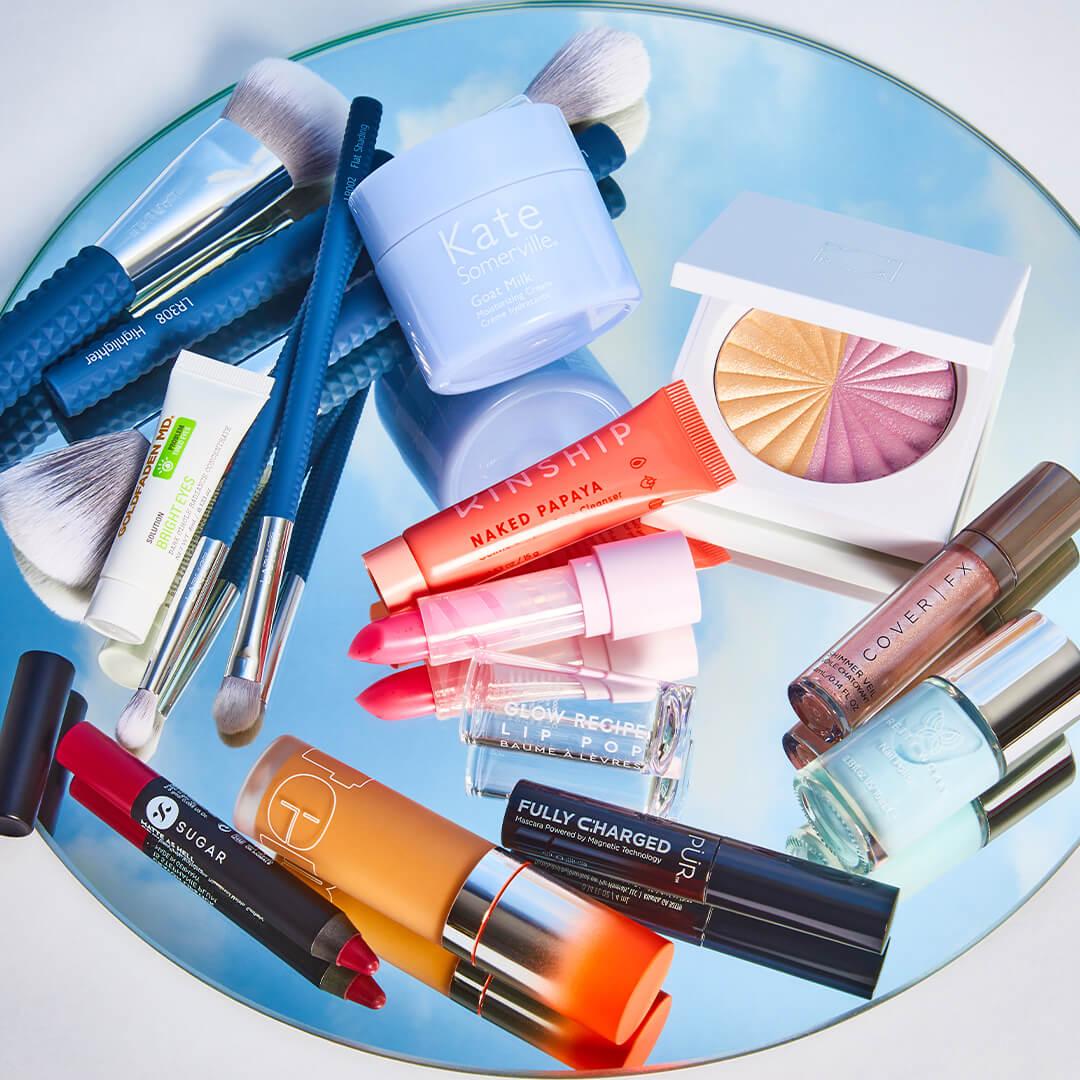 Image of nail, skincare, and makeup products and tools on round mirror with reflection of the sky Desktop