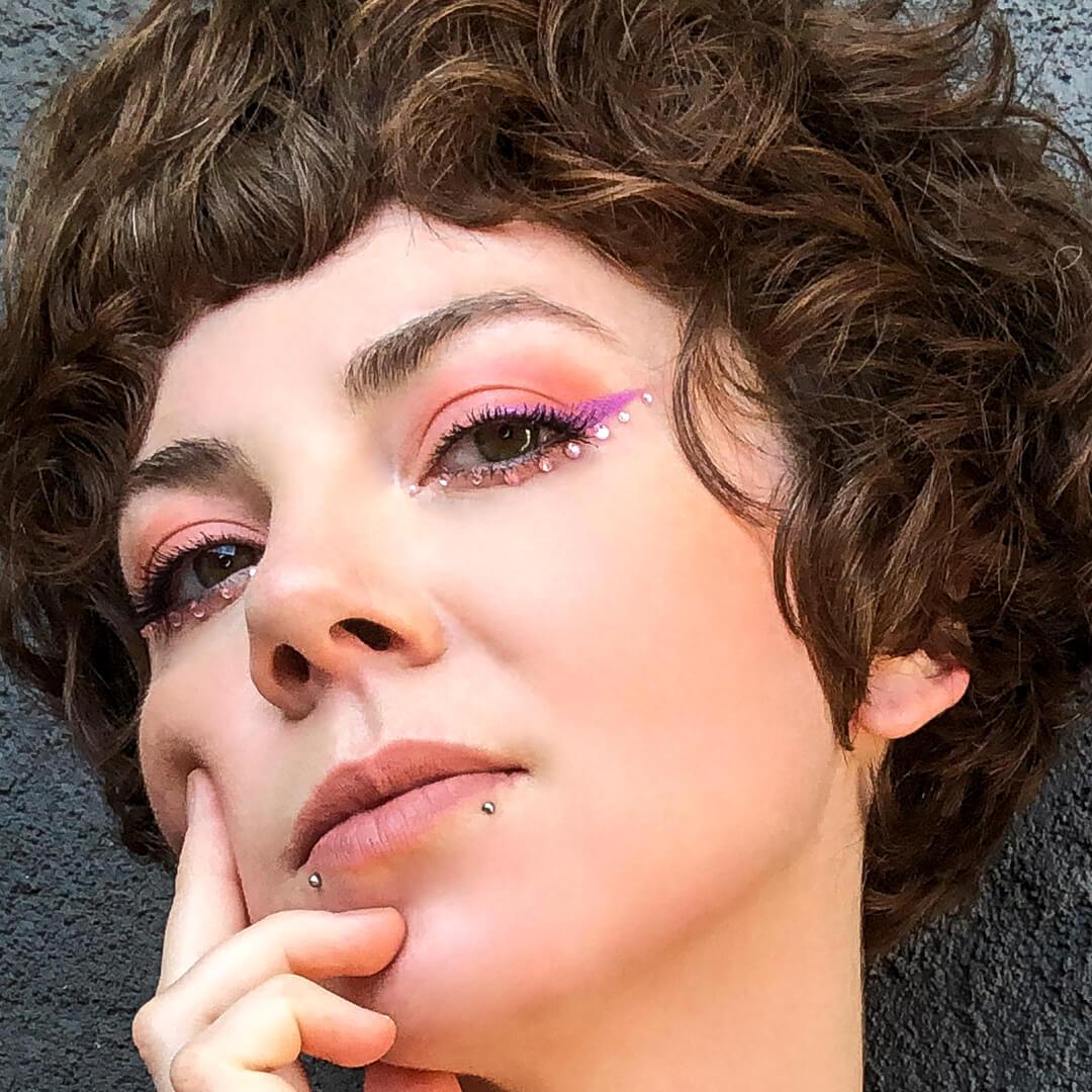 Close-up image of Kirsten Colemen rocking a pink rhinestone makeup look Desktop