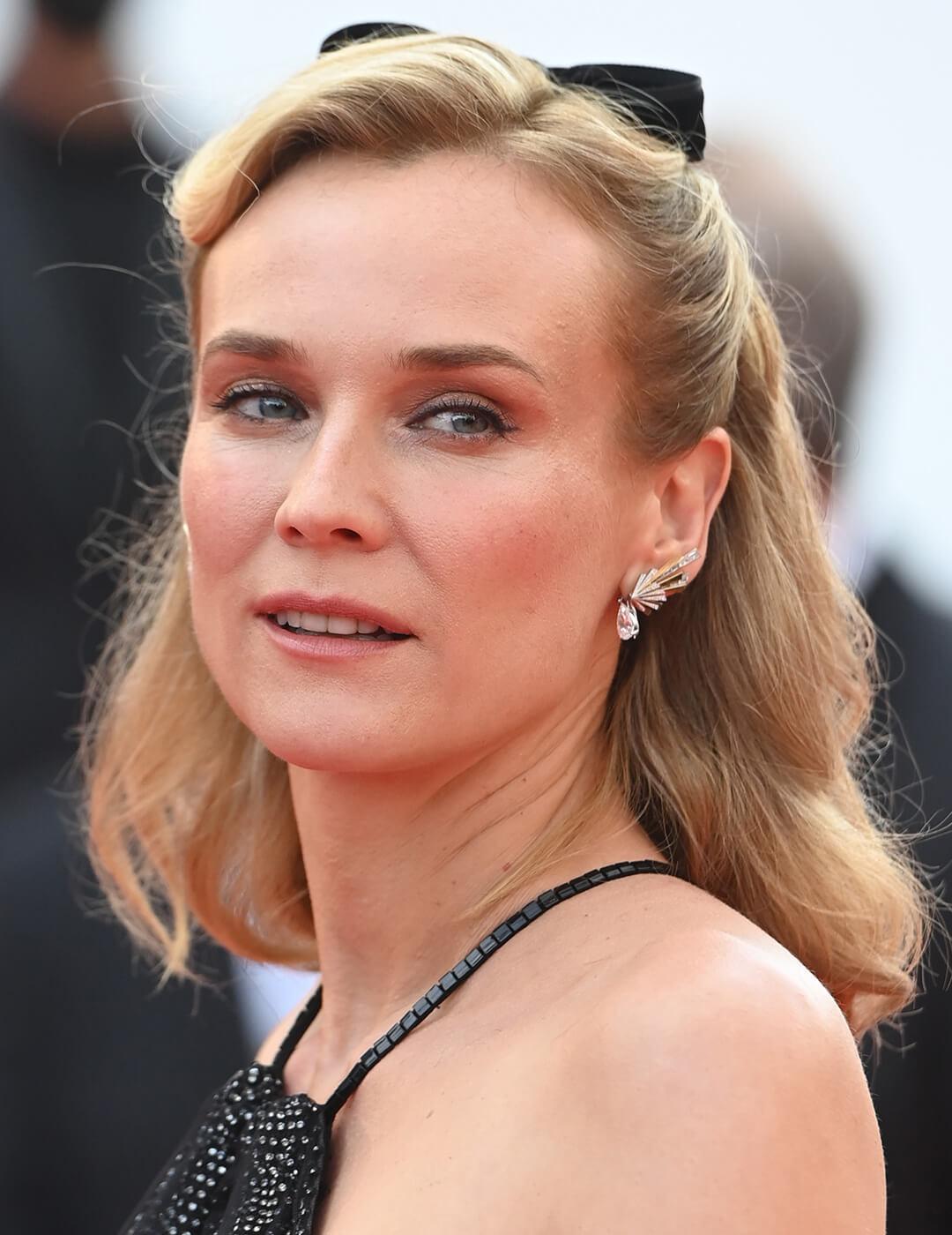 Diane Kruger rocking a retro-inspired half updo hairstyle with matching black velvet bow at the red carpet Mobile