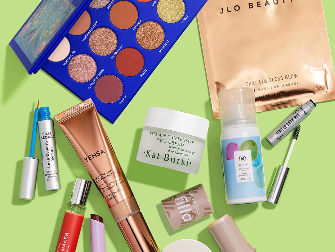 Beauty and makeup products from various brands scattered on lime green background Desktop