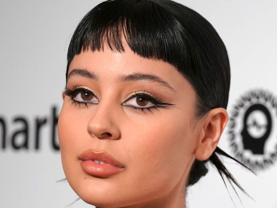 Close-up of Alexa Demie rocking short bangs and a graphic eyeliner makeup look Desktop