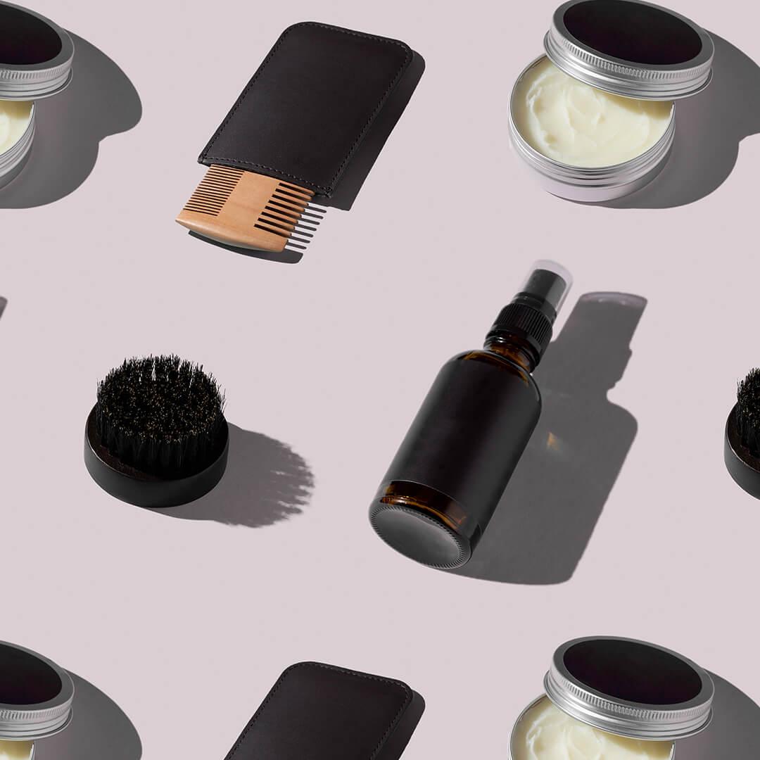 A photo of various products for grooming the beard laid on a pink background Mobile