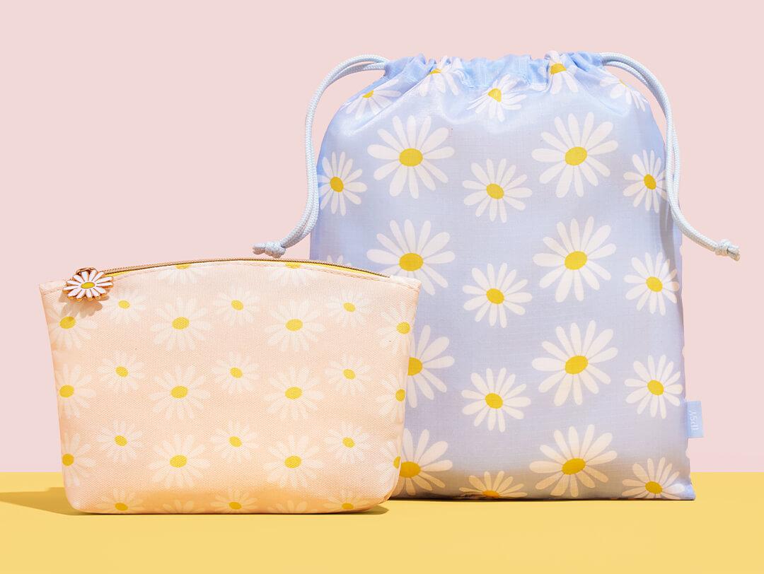 April 2022 IPSY Glam Bag and Glam Bag Plus bags on pink and yellow background Desktop