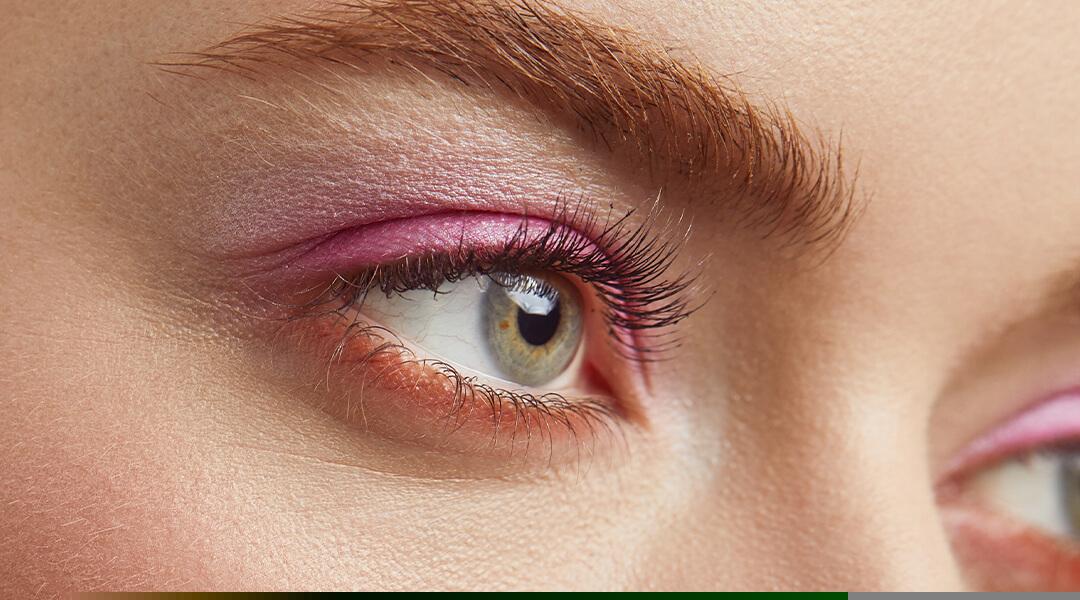 A close-up image of a model's eyes and eyelashes. Desktop
