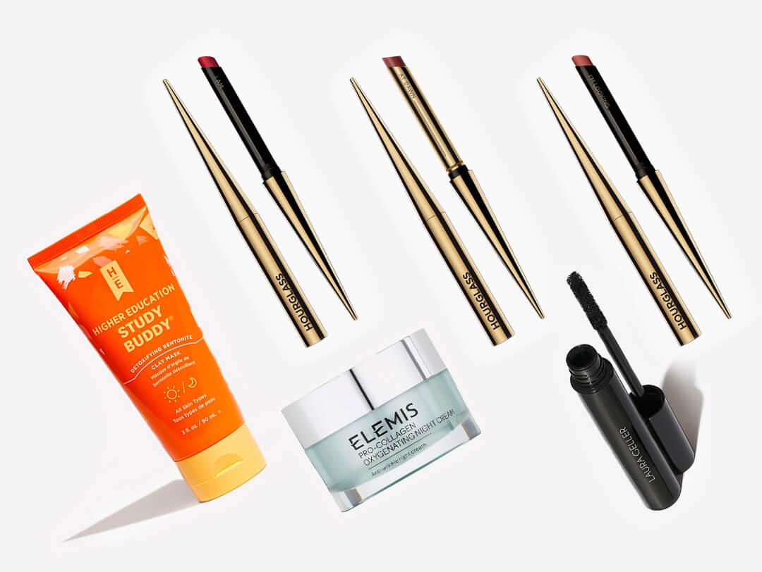 Beauty products and tools from various brands on white background Desktop