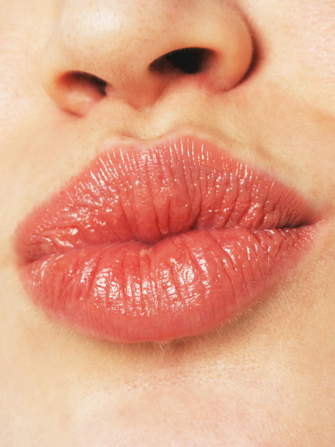 Close-up of a young woman pouting her juicy lips Desktop